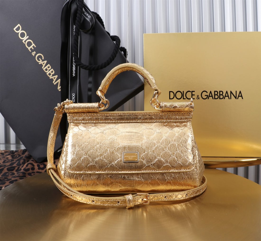 Dolce & Gabbana: Dolce & Gabbana's iconic snakeskin Sicily collection is now presented in a compact version, offering easy storage for frequently used items. Unique and stylish, it features a hidden magnetic closure o