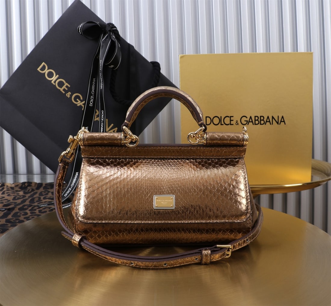 Dolce & Gabbana: Dolce & Gabbana's iconic snakeskin Sicily collection is now presented in a compact version, offering easy storage for frequently used items. Unique and stylish, it features a hidden magnetic closure o