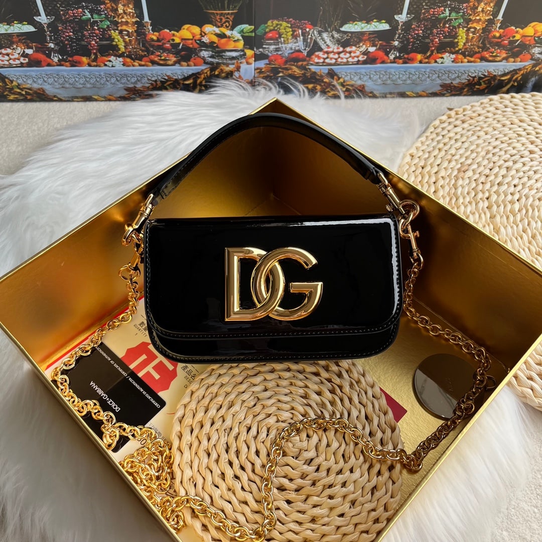Dolce & Gabbana: Dolce & Gabbana's exquisitely handcrafted bag can be carried by hand, over the shoulder, or crossbody. The base features a genuine gold-plated DG logo, a concealed magnetic closure on the front flap, 