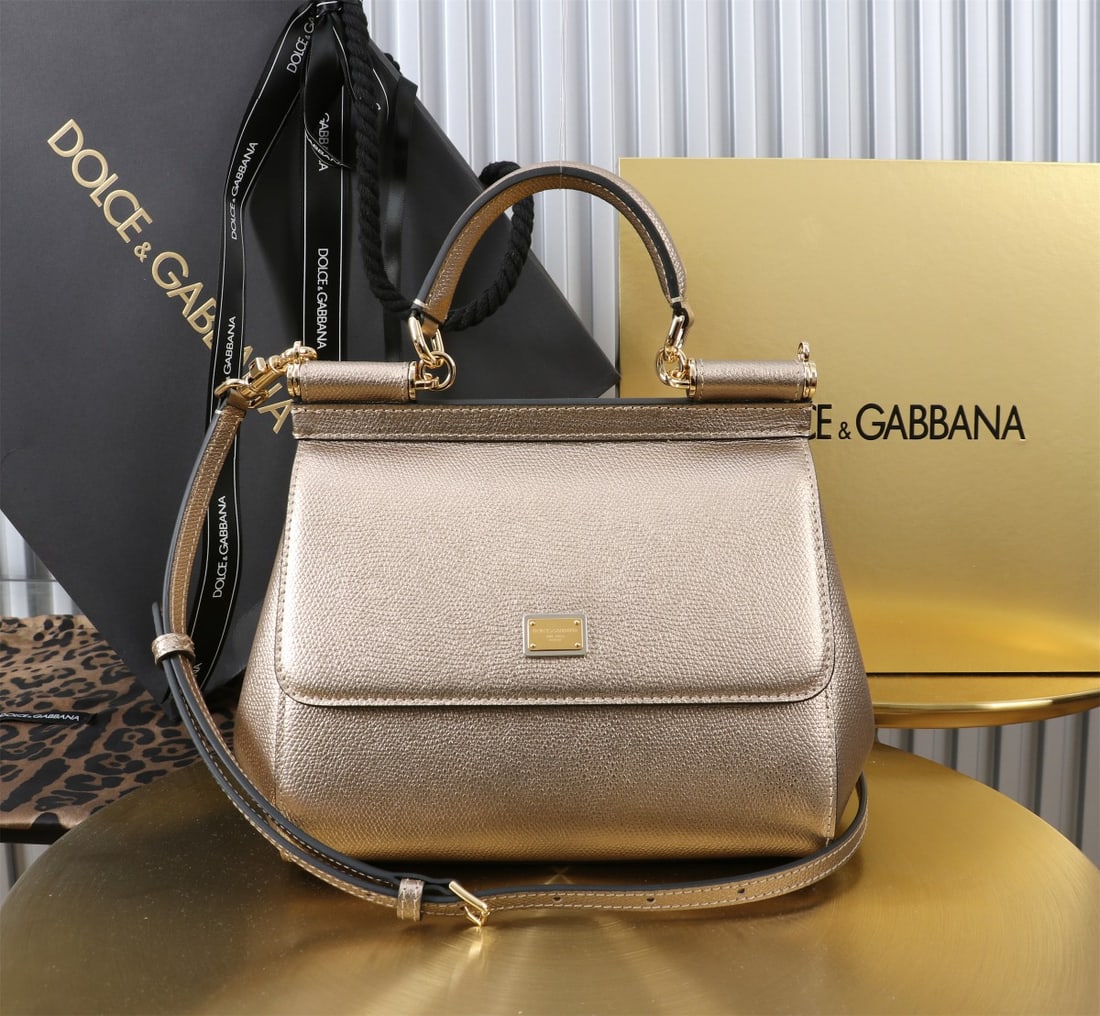 Dolce & Gabbana: The iconic Dolce & Gabbana Sicily is now presented in a compact version, offering easy storage for frequently used items. Its unique design features a hidden magnetic closure on the front flap. Size: 
