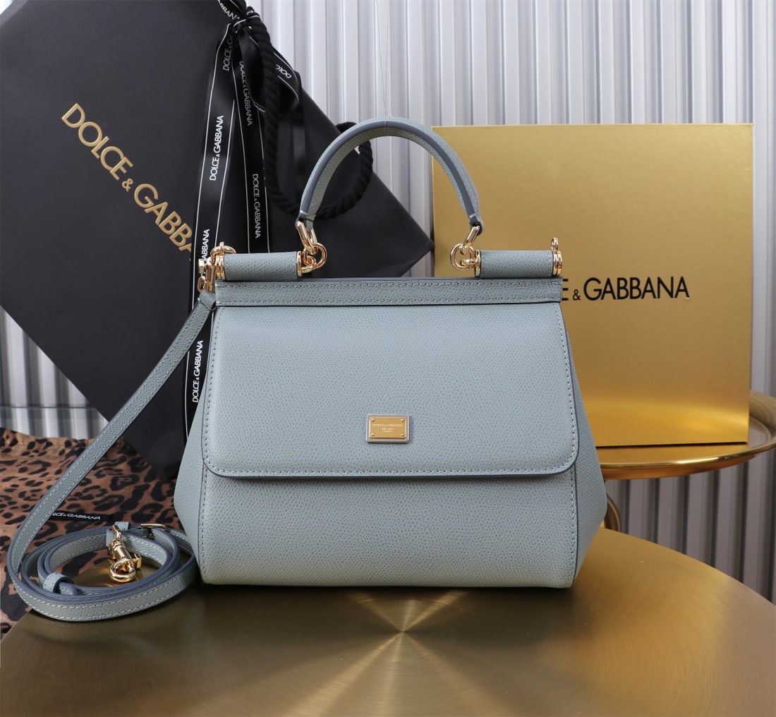 Dolce & Gabbana: The iconic Dolce & Gabbana Sicily is now presented in a compact version, offering easy storage for frequently used items. Its unique design features a hidden magnetic closure on the front flap. Size: 