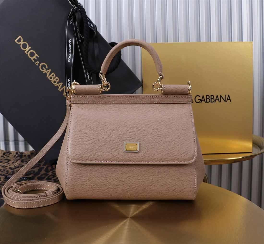 Dolce & Gabbana: The iconic Dolce & Gabbana Sicily is now presented in a compact version, offering easy storage for frequently used items. Its unique design features a hidden magnetic closure on the front flap. Size: 