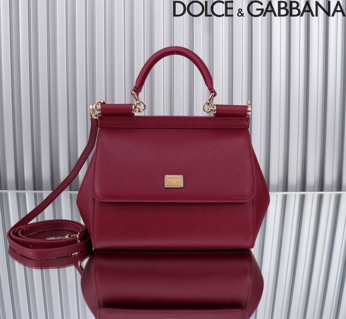 Dolce & Gabbana: The iconic Dolce & Gabbana Sicily is now presented in a compact version, offering easy storage for frequently used items. Its unique design features a hidden magnetic closure on the front flap. Size: 