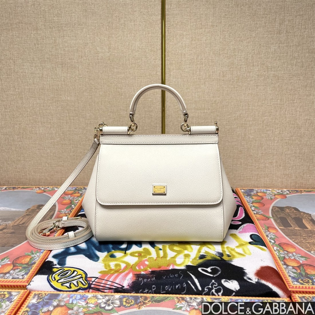 Dolce & Gabbana: The iconic Dolce & Gabbana Sicily is now presented in a compact version, offering easy storage for frequently used items. Its unique design features a hidden magnetic closure on the front flap. Size: 