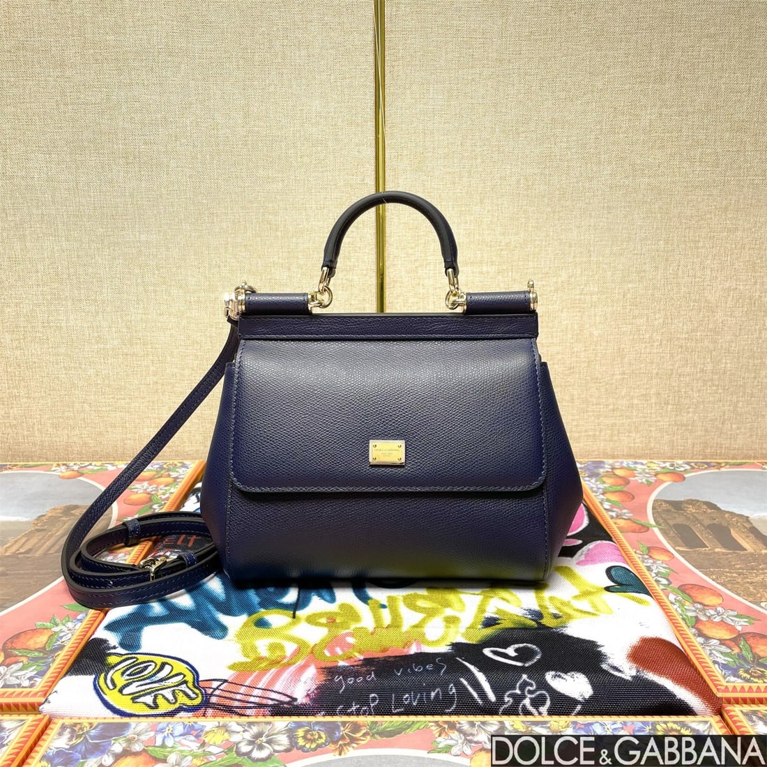 Dolce & Gabbana: The iconic Dolce & Gabbana Sicily is now presented in a compact version, offering easy storage for frequently used items. Its unique design features a hidden magnetic closure on the front flap. Size: 