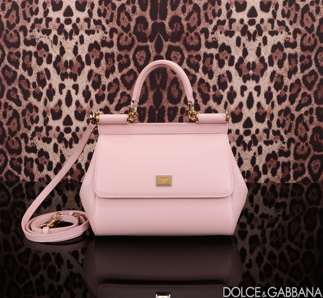 Dolce & Gabbana: The iconic Dolce & Gabbana Sicily is now presented in a compact version, offering easy storage for frequently used items. Its unique design features a hidden magnetic closure on the front flap. Size: 
