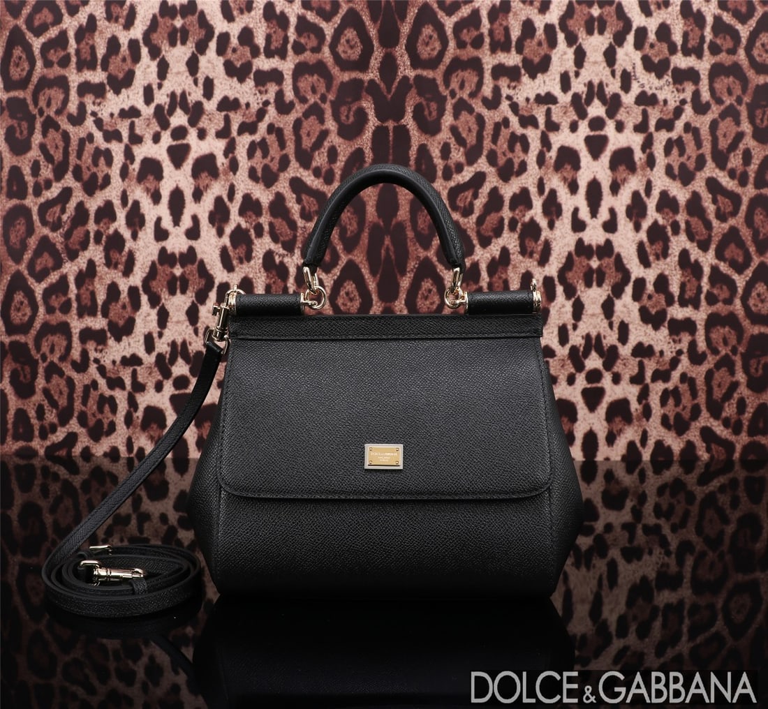 Dolce & Gabbana: The iconic Dolce & Gabbana Sicily is now presented in a compact version, offering easy storage for frequently used items. Its unique design features a hidden magnetic closure on the front flap. Size: 