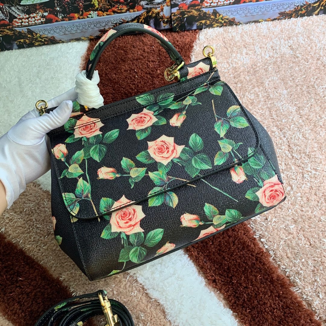 Dolce & Gabbana: Dolce & Gabbana leather printed bag, can be worn crossbody or carried by hand, features a mirror, exudes style and sophistication, and pairs perfectly with any outfit. DG always delivers endless surpr