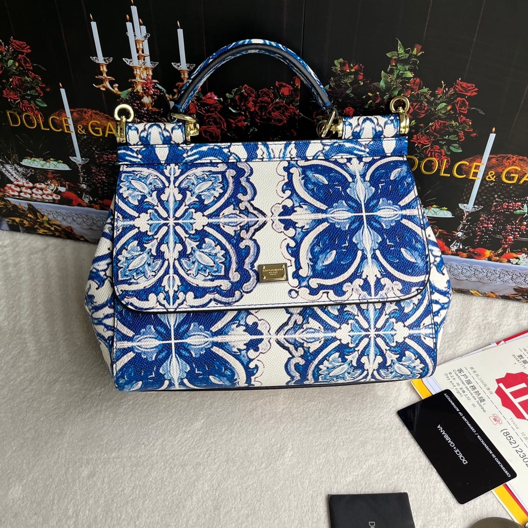 Dolce & Gabbana: Dolce & Gabbana leather printed bag, can be worn crossbody or carried by hand, features a mirror, exudes style and sophistication, and pairs perfectly with any outfit. DG always delivers endless surpr