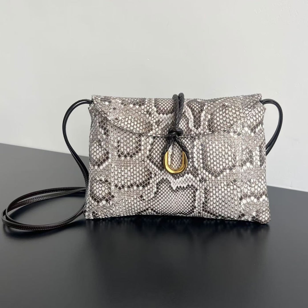 Bottega Veneta Liberta: The Bottega Veneta Liberta snakeskin crossbody bag is crafted from Vietnamese python skin. The raised, intricate scales and vibrant colors give the bag an unparalleled texture and feel. The metal clas