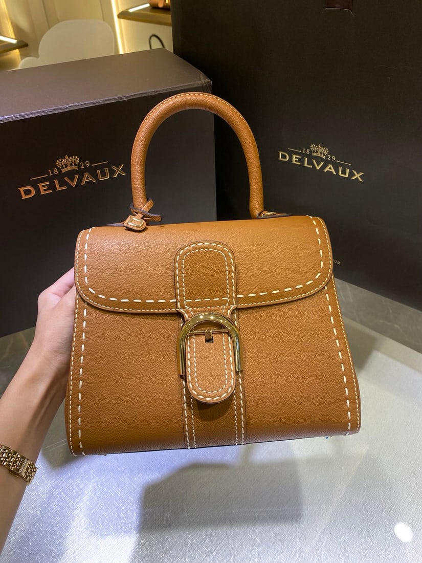 Delvaux: The Delvaux Brillant PM bag, crafted from Rodeo Calf grain calfskin, is a classic design from the Delvaux Spring Summer 2022 collection. Born in 1958, it's a symbol of the Delvaux house. The bag stand