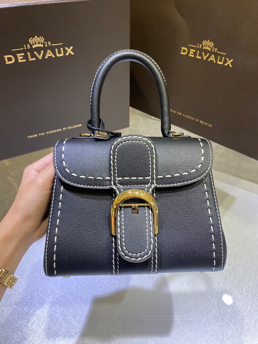 Delvaux: The Delvaux black-stitched mini Delvaux Fall Winter 2022 collection features a classic design born in 1958, a symbol of the Delvaux house. Crafted from Rodeo Calf grained calfskin, the Brillant bag st