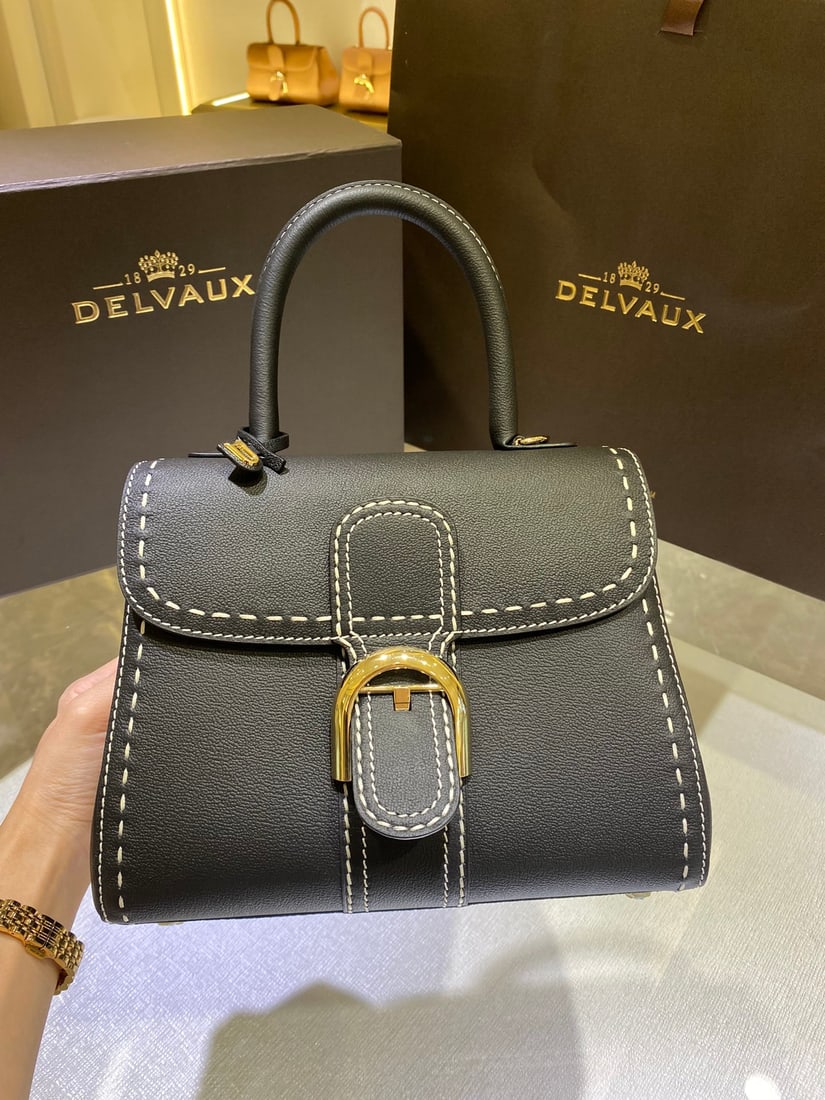 Delvaux: The Delvaux Brillant PM bag, with its black exterior stitching, is a classic design from the Delvaux Fall Winter 2022 collection. Born in 1958, it's a symbol of the Delvaux house. Crafted from Rodeo C