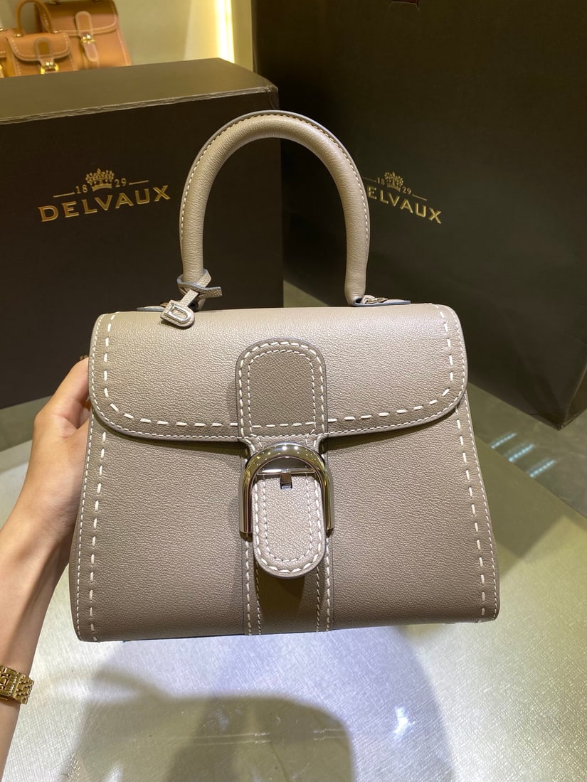 Delvaux: The Delvaux Brillant PM bag, with its milky-grey exterior stitching, is a classic design from the Delvaux Spring Summer 2022 collection. Born in 1958, this iconic style is a symbol of the Delvaux hous