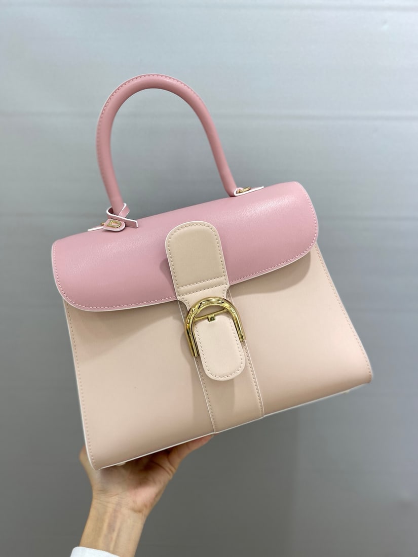 Delvaux brillant: This pink tri-tone Delvaux brillant, a Belgian royal warrant holder, features a double-ring brillant box leather upper with lambskin lining, an adjustable long shoulder strap, a mirror, and a small ch