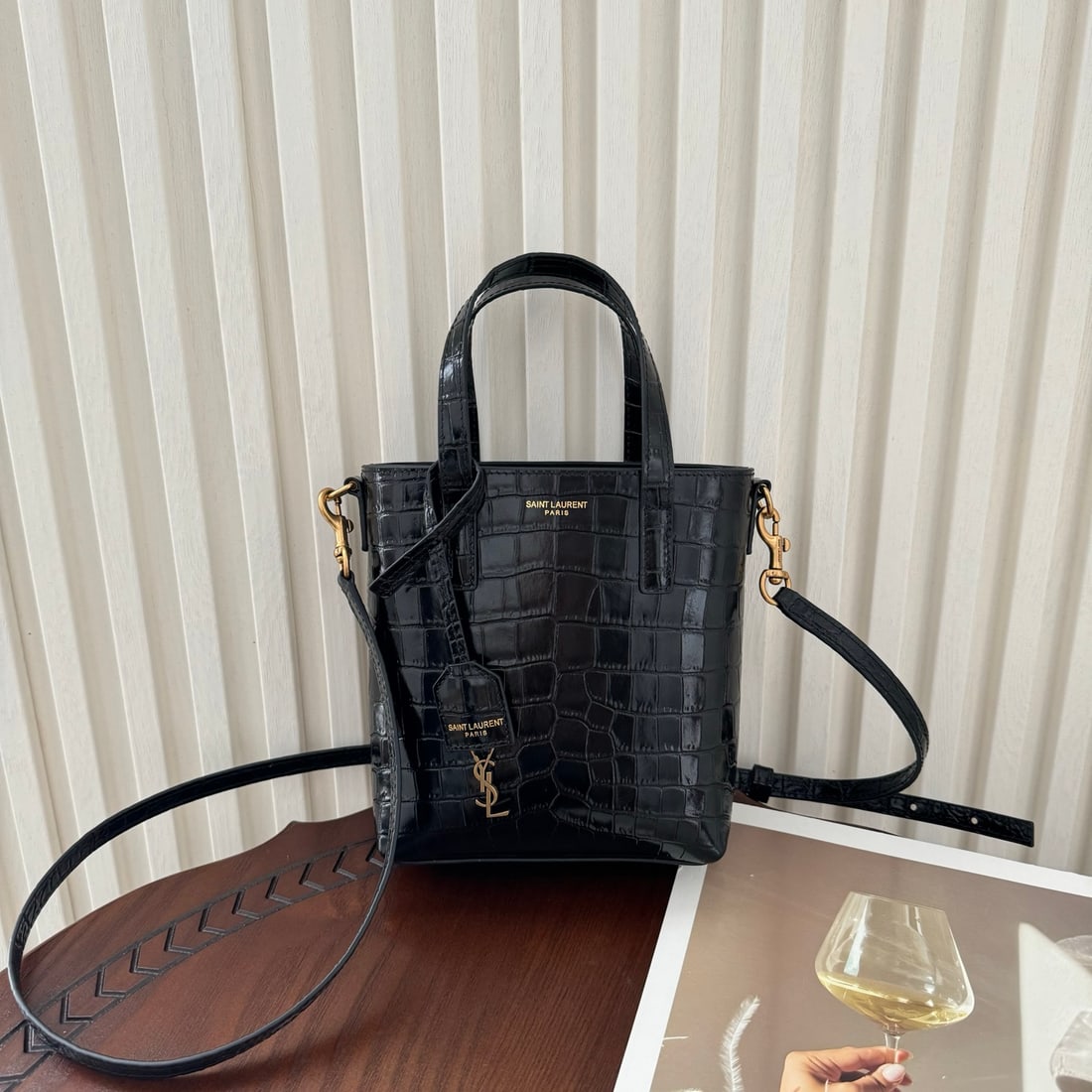 Yves Saint Laurent Paris Mini Shopping Bag: The Paris mini tote bag is crafted from calfskin with a crocodile-embossed pattern, exuding a luxurious feel. It features vintage bronze hardware, a detachable and adjustable shoulder strap, and a cla