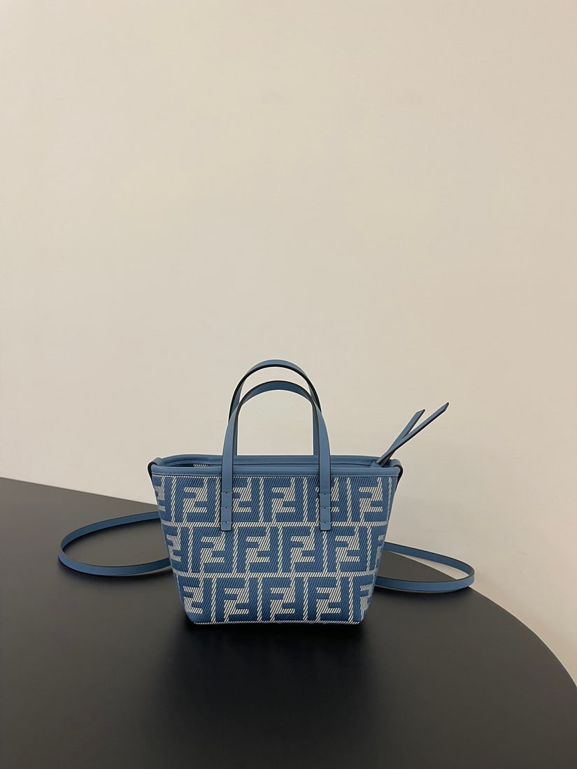 Fendi: This denim jacquard mini roll bag features a retro-chic look with calfskin leather and blue lettering. The included detachable long calfskin shoulder strap allows for crossbody or hand carry. It's spa