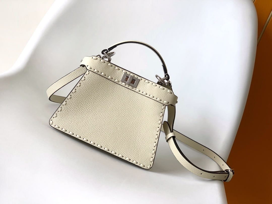 Fendi conic Peekaboo ISeeU Mini: White Fendi conic Peekaboo ISeeU Mini calfskin leather, large size with tonal topstitching and hand-stitched details. Features a classic twist lock, two compartments, handle, and adjustable detachable