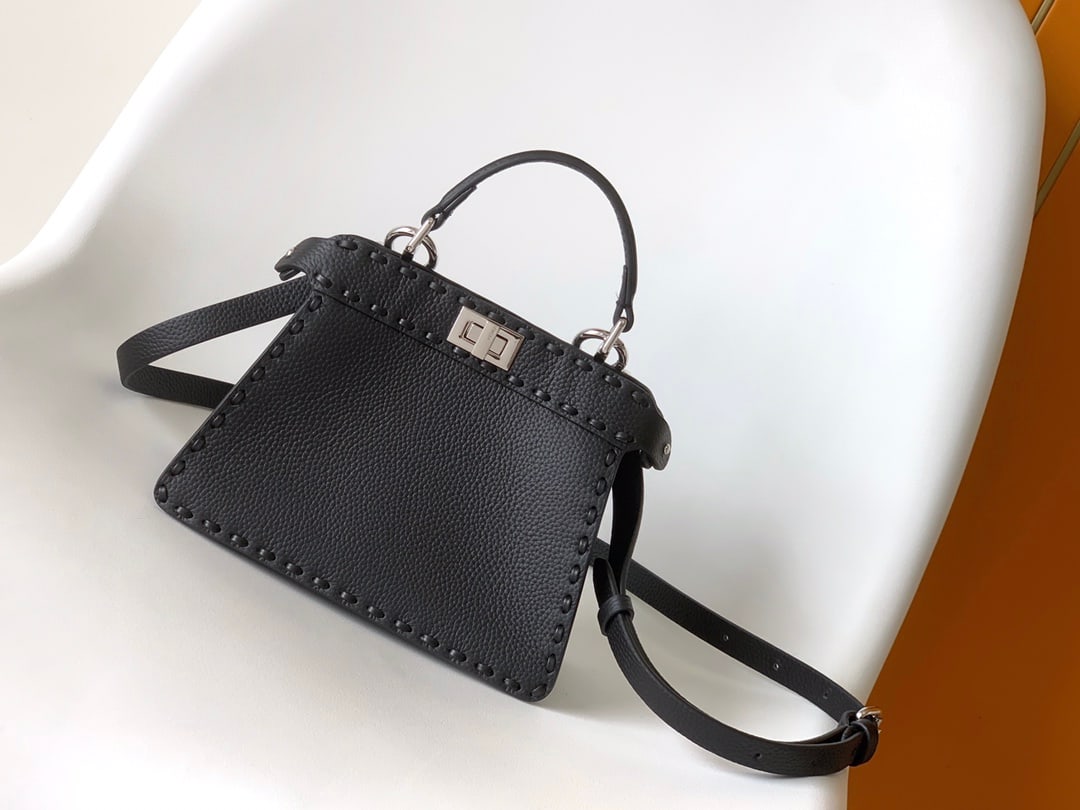 Fendi conic Peekaboo ISeeU Mini: Black Fendi conic Peekaboo ISeeU Mini, made of calfskin leather, large size with topstitching in the same color, hand-stitched, adorned with a classic twist lock, two compartments, handle, and adjusta