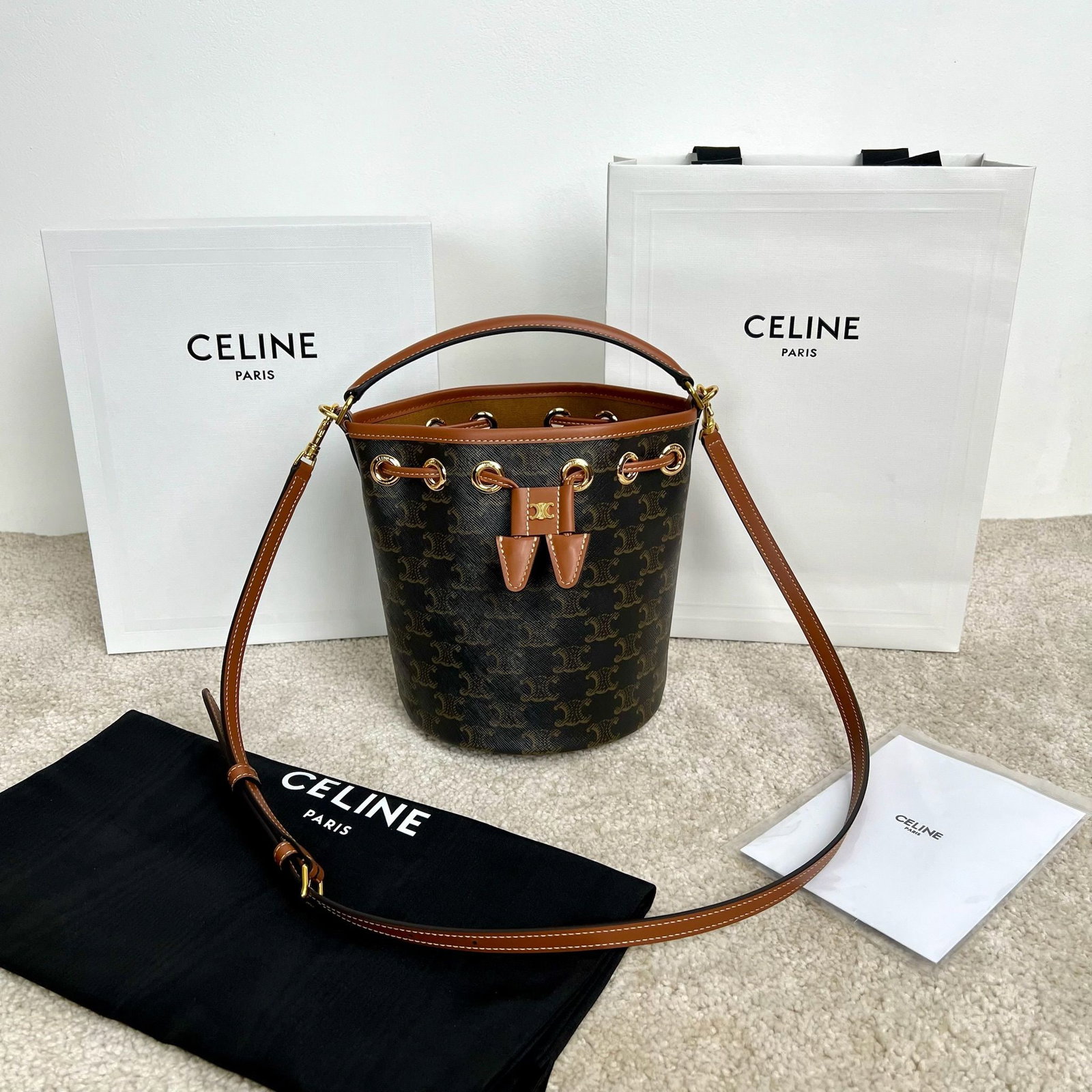 Celine: TEEN CLARA logo print cowhide leather handbag, dimensions 16 x 19 x 16 cm. Logo print, cowhide leather trim, fabric lining, drawstring leather straps for handles, shoulder bag, and crossbody, decorati
