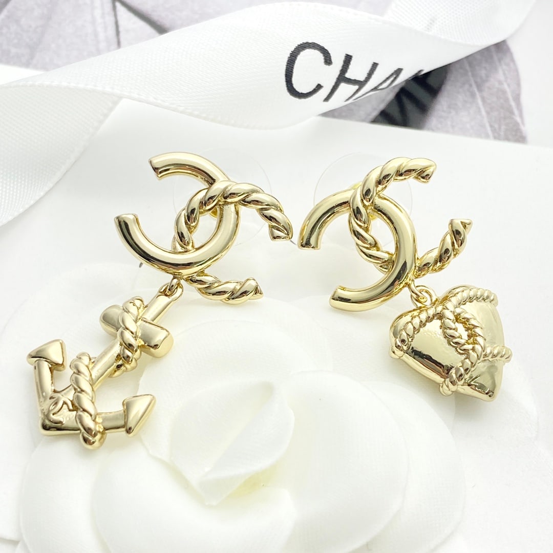 Chanel earrings: Chanel asymmetrical anchor heart rope double C earrings. The rope pattern is wrapped around the double C anchor heart design, creating a very fashionable and casual look with a cartoonish feel. The as