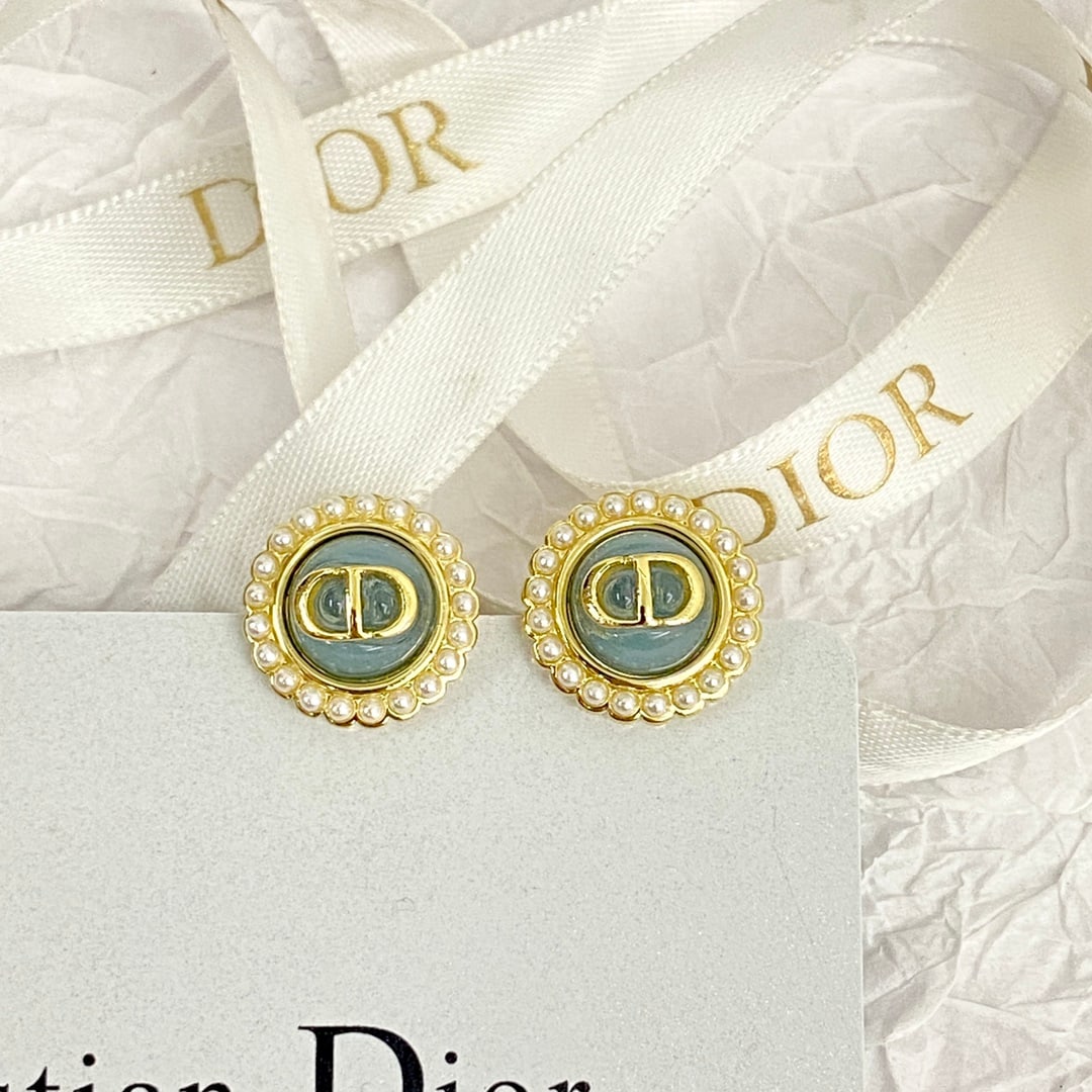 Dior button blue pearl stud earrings: Dior button-style blue pearl earrings. Round studs surround a pearl with a gold CD logo in the center. Exquisite, small, vintage, classic, elegant, and subtly feminine. A wonderful gift for you or you