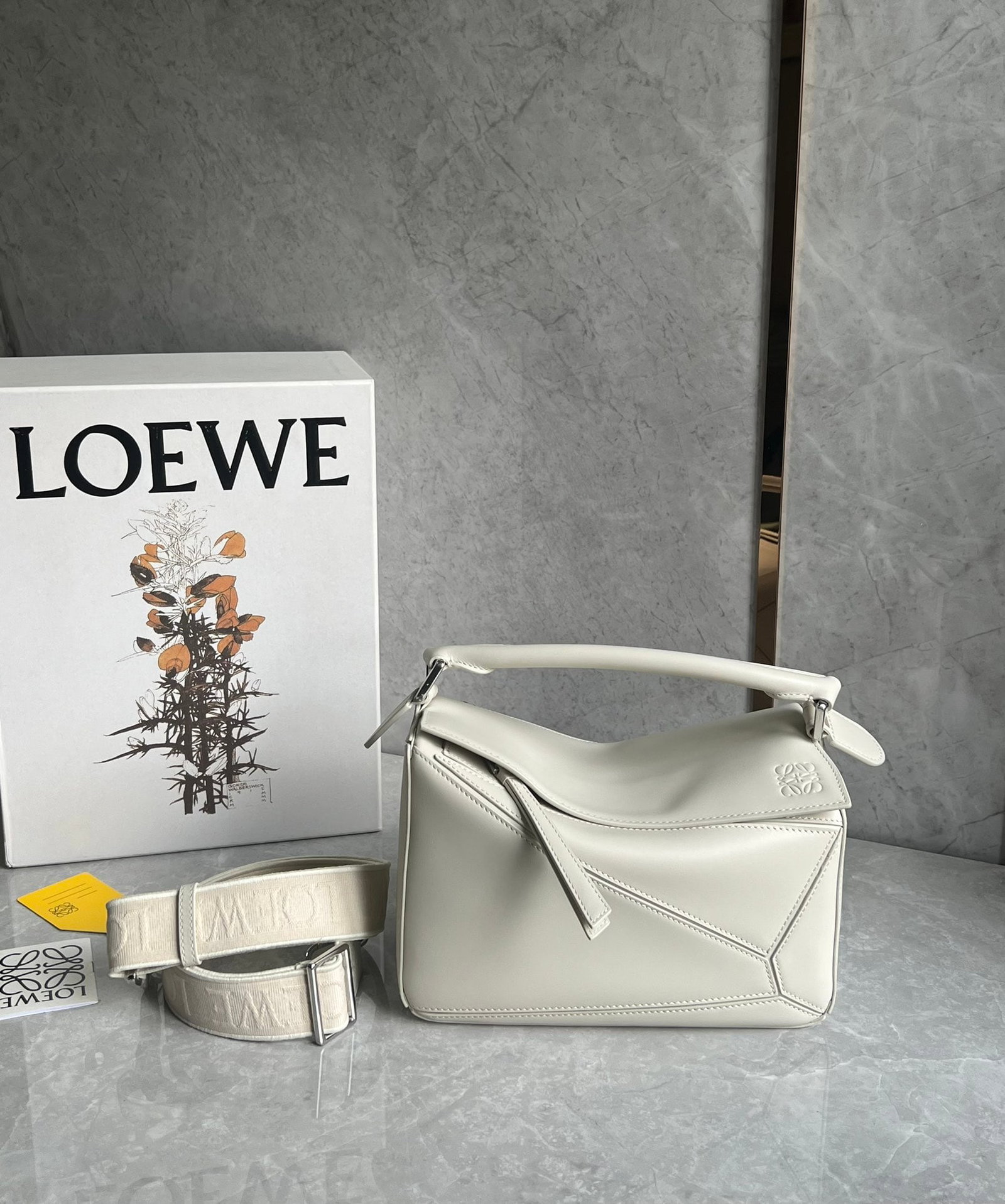 LOEWE: LOEWE products exude a tangible sense of quality, making them instantly eye-catching. The classic design features a woven jacquard shoulder strap. Size: 24X10X14cm. A wonderful gift for you or your lo