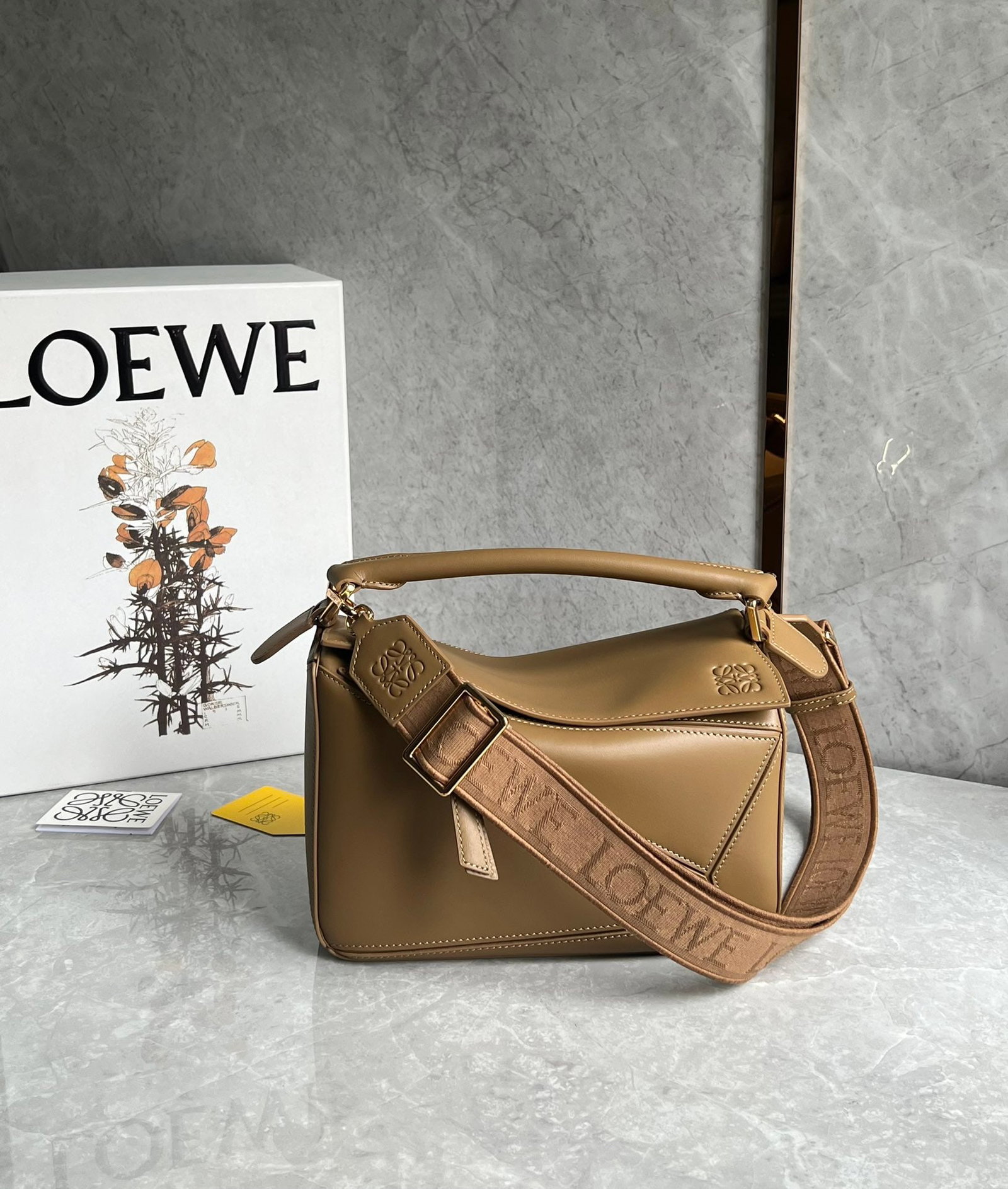 LOEWE: LOEWE products exude a tangible sense of quality, making them instantly eye-catching. The classic design paired with a woven jacquard shoulder strap. Size: 24X10X14cm. A wonderful gift for you or your