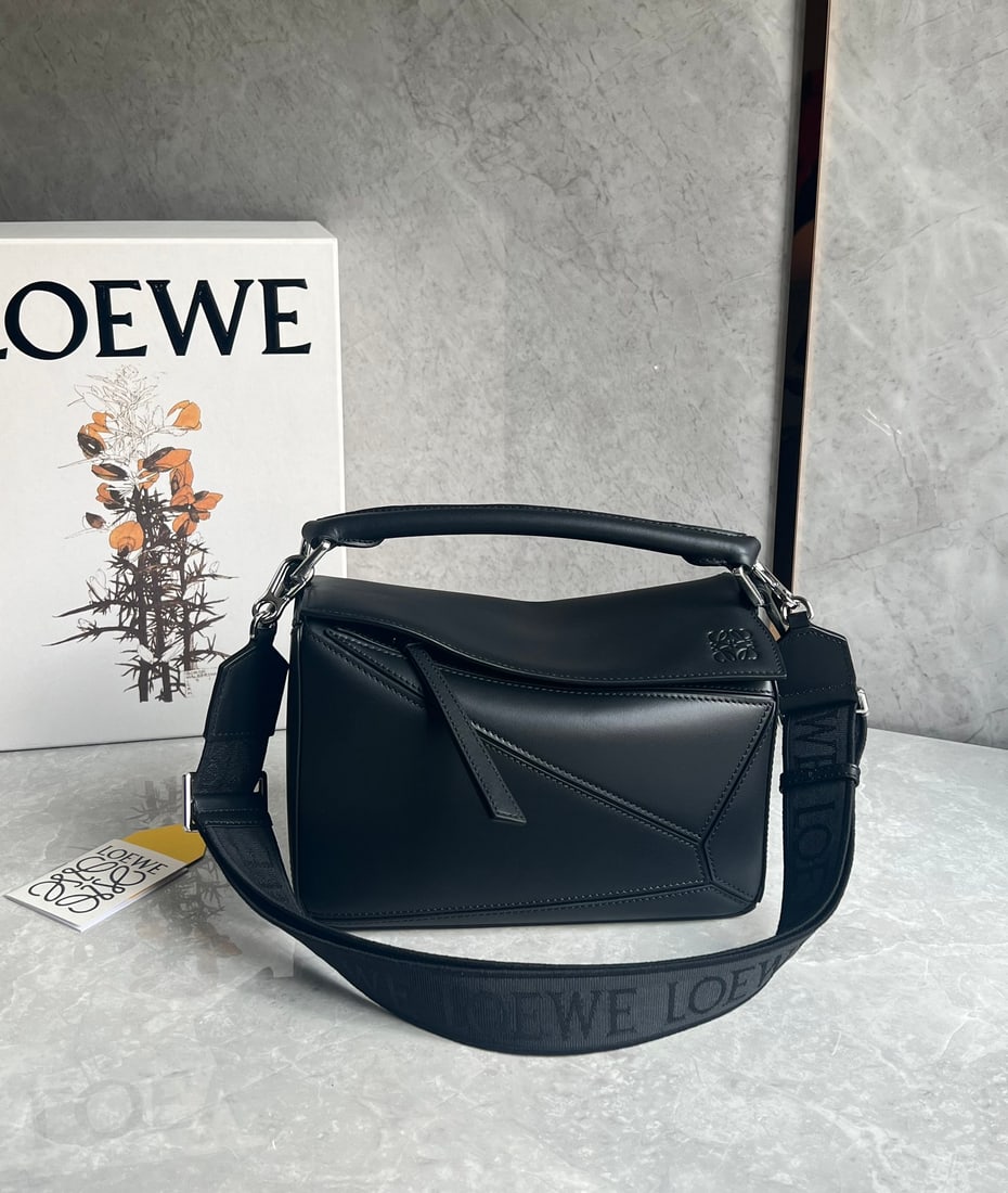 LOEWE: LOEWE products exude a tangible sense of quality, making them instantly eye-catching. The classic design features a woven jacquard shoulder strap. Size: 24X10X14cm. A wonderful gift for you or your lo