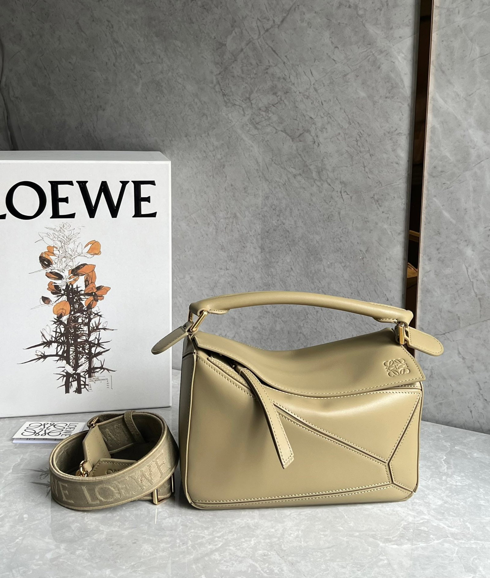 LOEWE: LOEWE products exude a tangible sense of quality, making them instantly eye-catching. The classic design paired with a woven jacquard shoulder strap. Size: 24X10X14cm. A wonderful gift for you or your