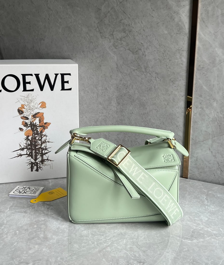 LOEWE: LOEWE products exude a tangible sense of quality, making them instantly eye-catching. The classic design paired with a woven jacquard shoulder strap. Size: 24X10X14cm. A wonderful gift for you or your