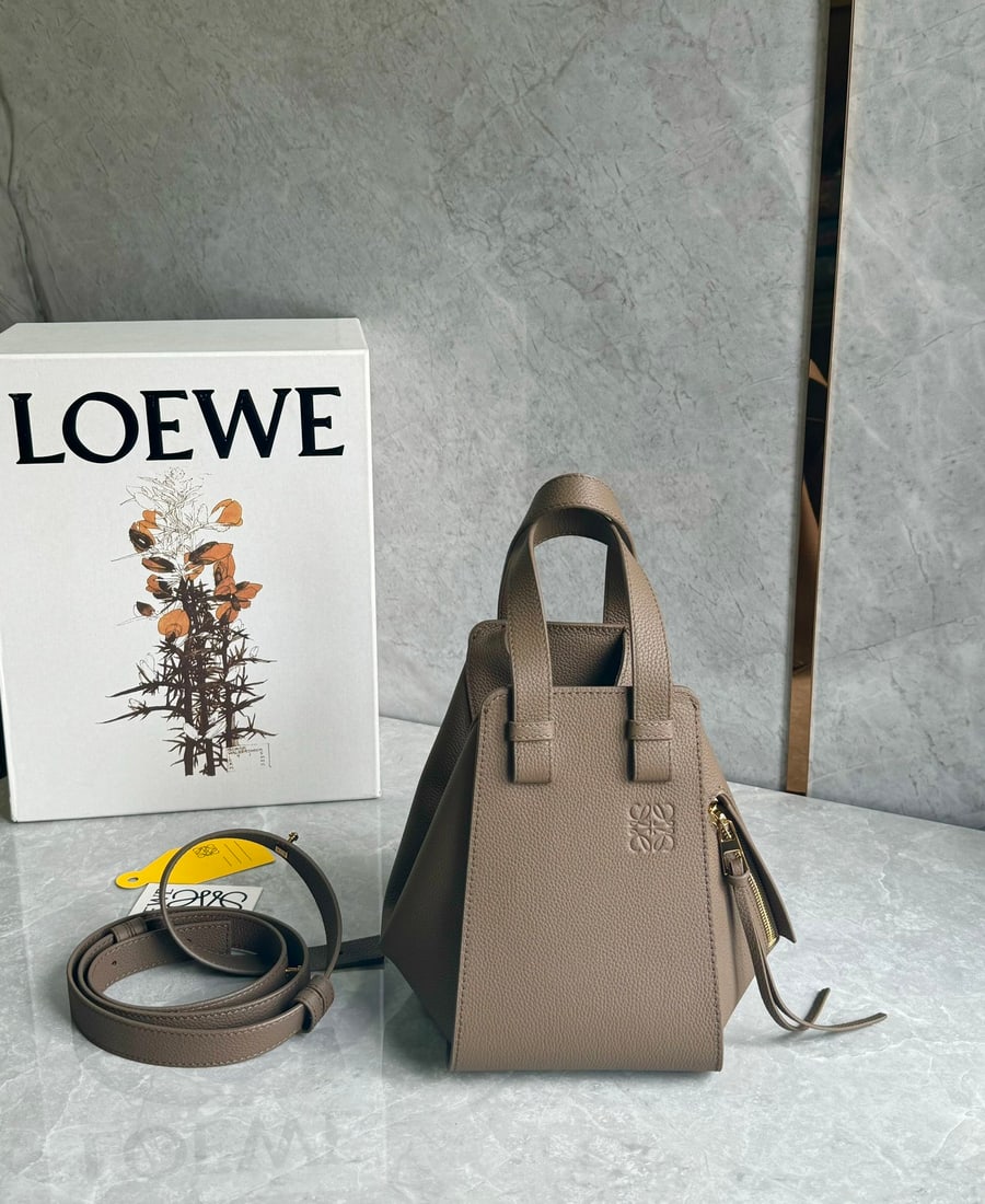 LOEWE: LOEWE's "Transformer" of the fashion world the Hammock bag. Perfect for everyday wear, casual occasions, or sophisticated looks. It can be carried by hand or crossbody, and boasts excellent capacity