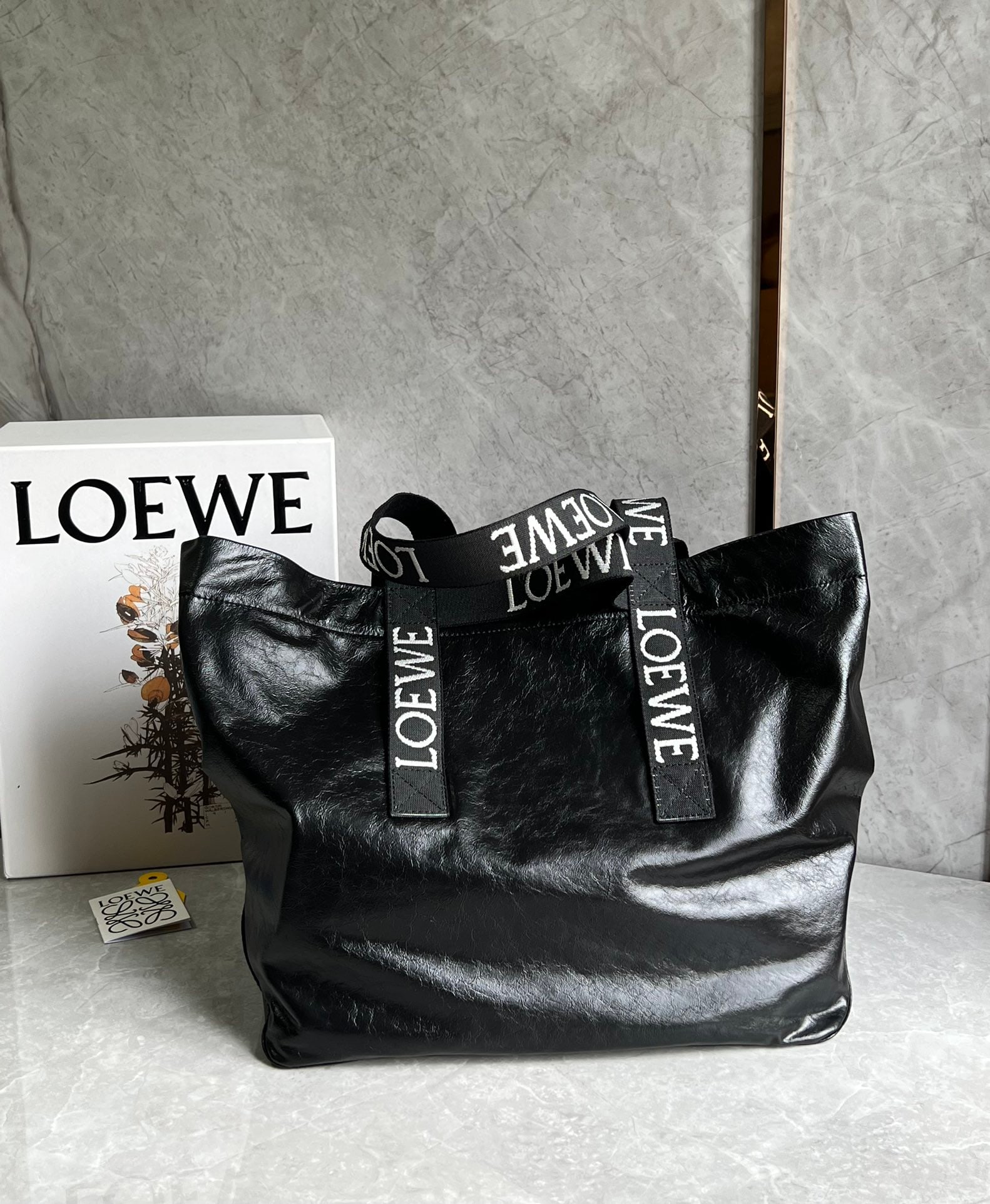 LOEWE: The LOEWE Fold Shopper tote bag diaper bag has a great, natural, relaxed yet stylish silhouette. Made of lightweight and comfortable paper-textured cowhide, it folds flat at the bottom and is a must-h