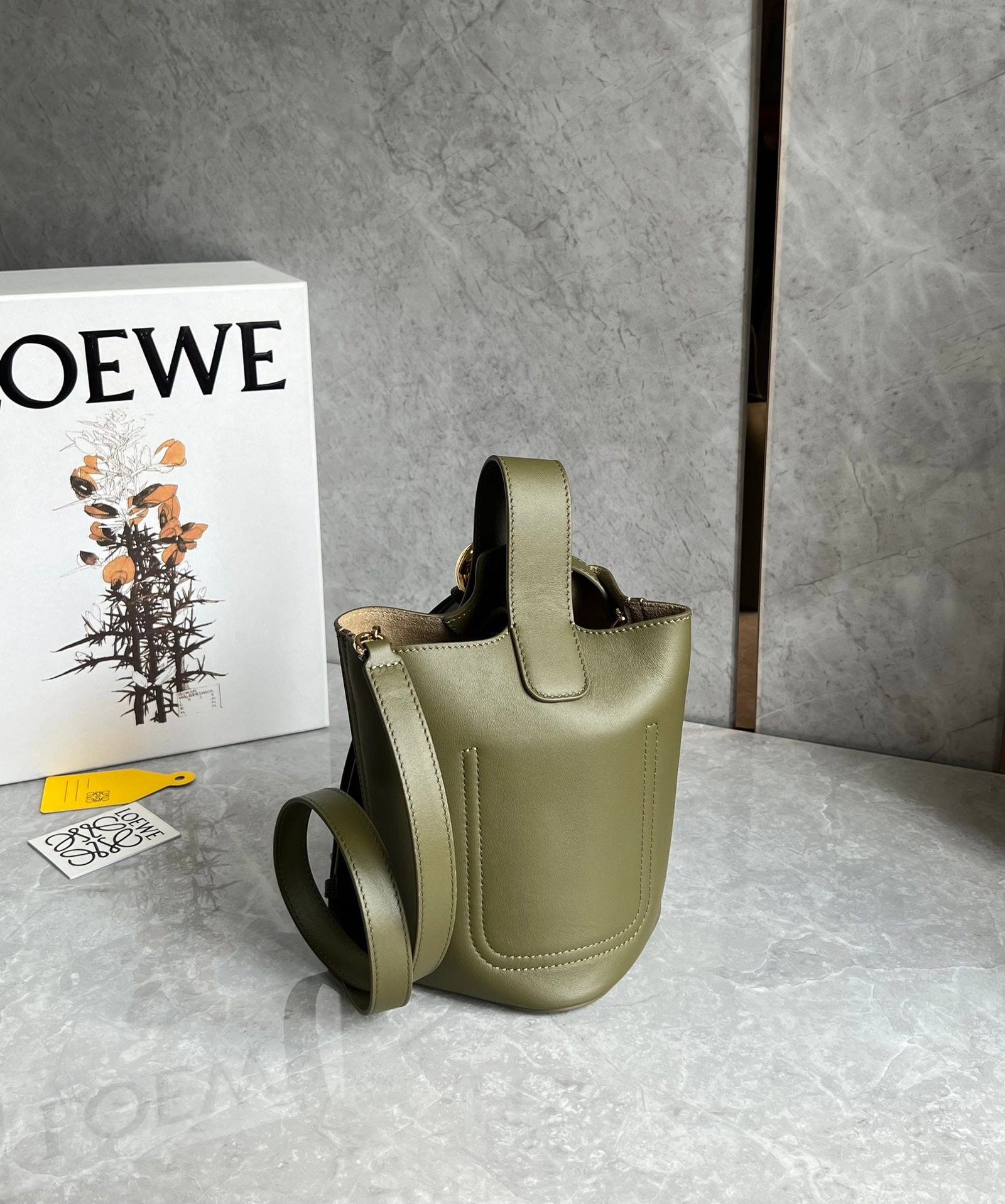 LOEWE: The Pebble bucket bag has a fantastic texture and a minimalist, sleek design. Its king-like capacity and versatile styling make it easy to carry by hand, crossbody, or under the arm. It's incredibly p