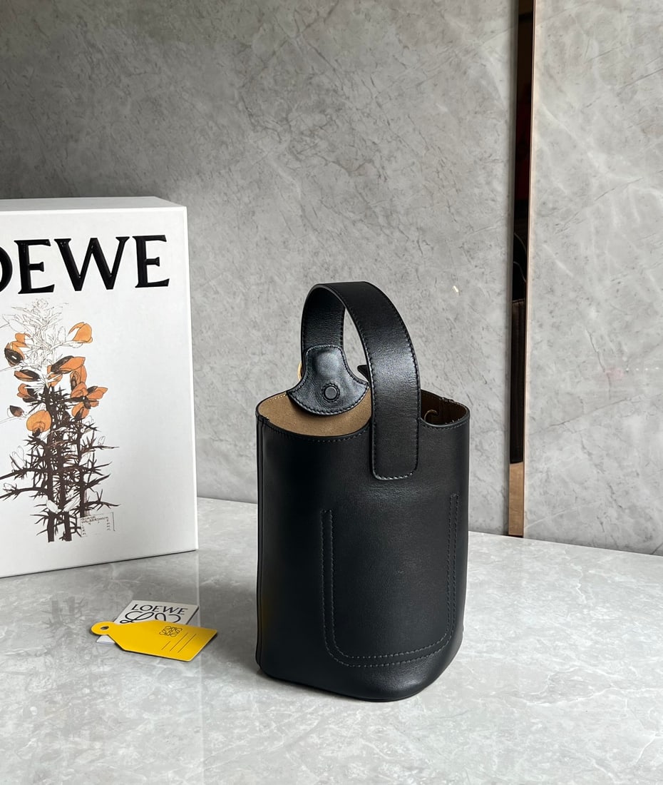LOEWE: The LOEWE Pebble bucket bag has a fantastic texture. Its minimalist and sleek bucket shape offers a king-like capacity and versatile styling. It can be carried by hand, crossbody, or under the arm, ma