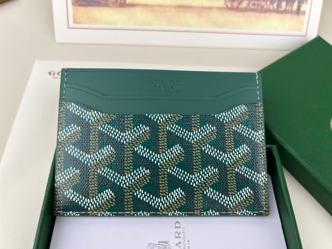 Goyard Saint-Sulpice: The Goyard Saint-Sulpice cardholder is compact and stylish, with a central pocket for cards, ID, or folded banknotes. Its petite size makes it perfect for a jacket or trouser pocket. It features deep 