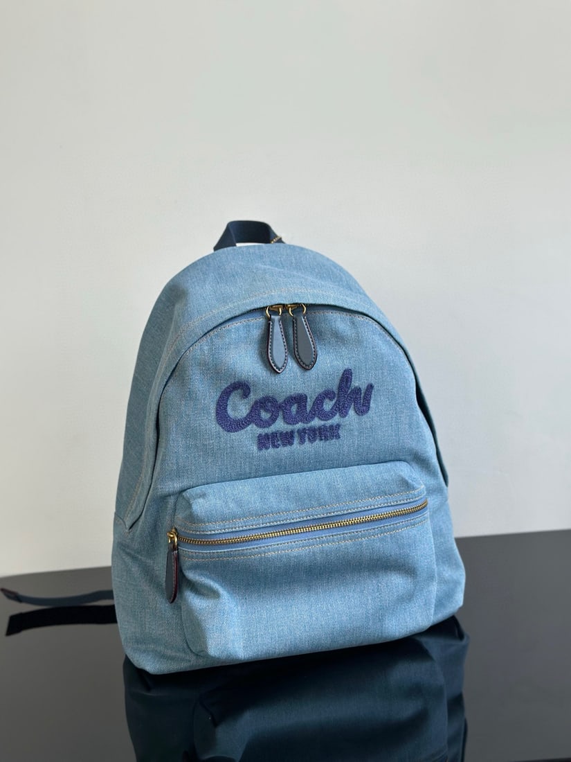 Coach: Coach denim backpack. This style is highly versatile and suits all body types. It's very soft, spacious, and offers a comfortable feel. It's perfect for travel and business trips. It has an interior l