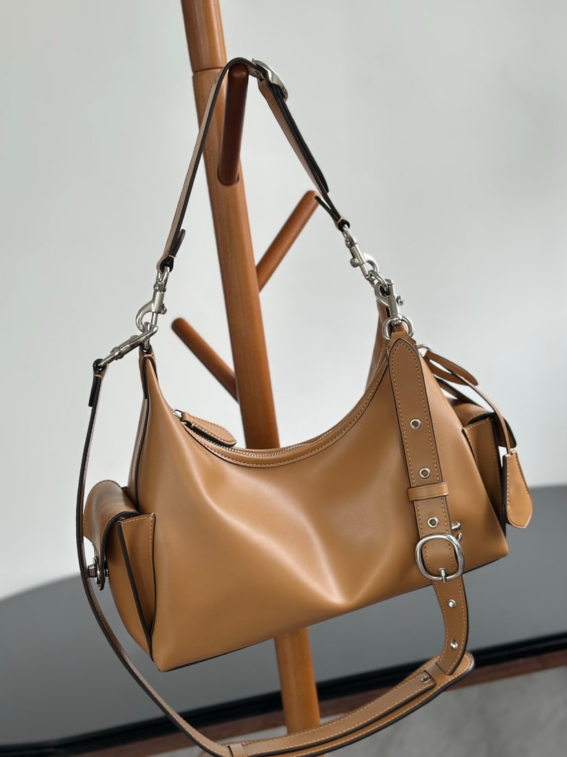 Coach Juliet: This new Coach Juliet bag is very unique and has a large capacity. It's unisex, with three interchangeable shoulder straps that can be worn as a top strap or used as decorative pendants, making it les