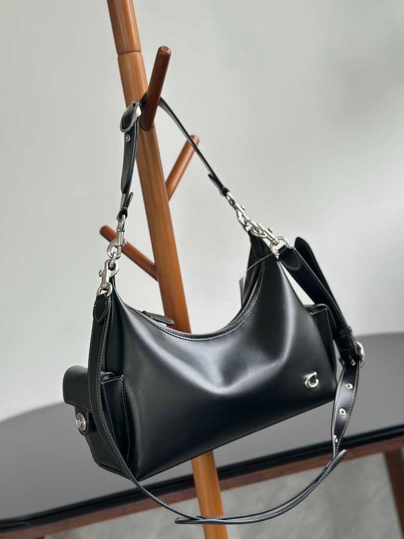 Coach Juliet: This new Coach Juliet bag is very unique and has a large capacity. It's unisex, with three interchangeable shoulder straps that can be worn as a top strap or used as decorative pendants, making it les
