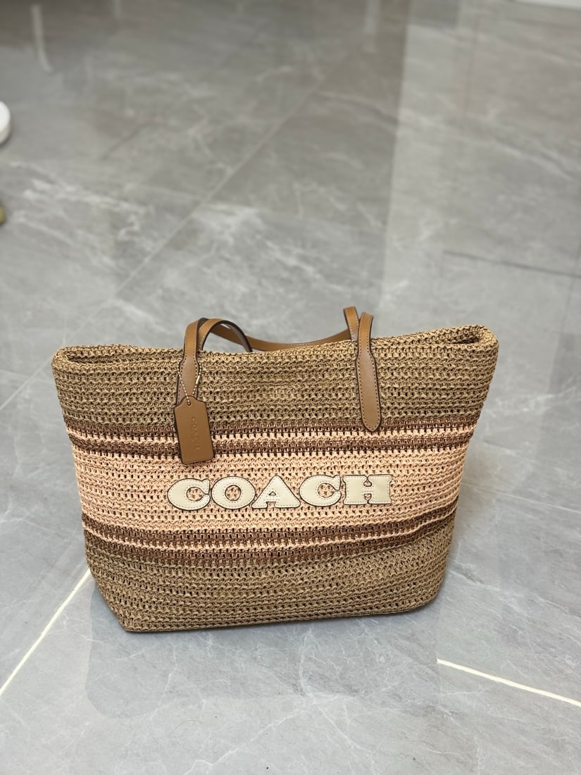 Coach Eco-friendly Woven Tote Bag: Coach eco-friendly woven tote bag. The weave is extremely fine, eliminating any discomfort or discomfort. Machine-woven, one-piece construction with multi-color patchwork. Large tote with ample capaci