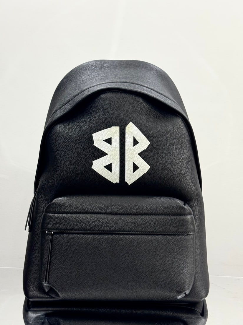 Balenciaga: The Balenciaga Everyday Backpack, part of Balenciaga's black and white collection, makes everyday styling easy. Although it's a casual backpack, the supple calfskin leather ensures a refined look. Dim