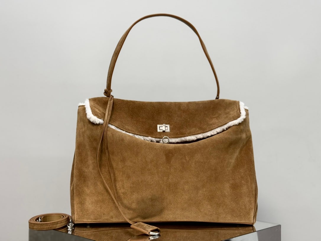 Balenciaga Rodeo Bag: The Balenciaga Rodeo Bag in dark brown suede is a must-mention for Fall Winter. Popular throughout 2024, the Rodeo bag pioneered a new style and was extremely popular among fashionistas. Its relaxed, 