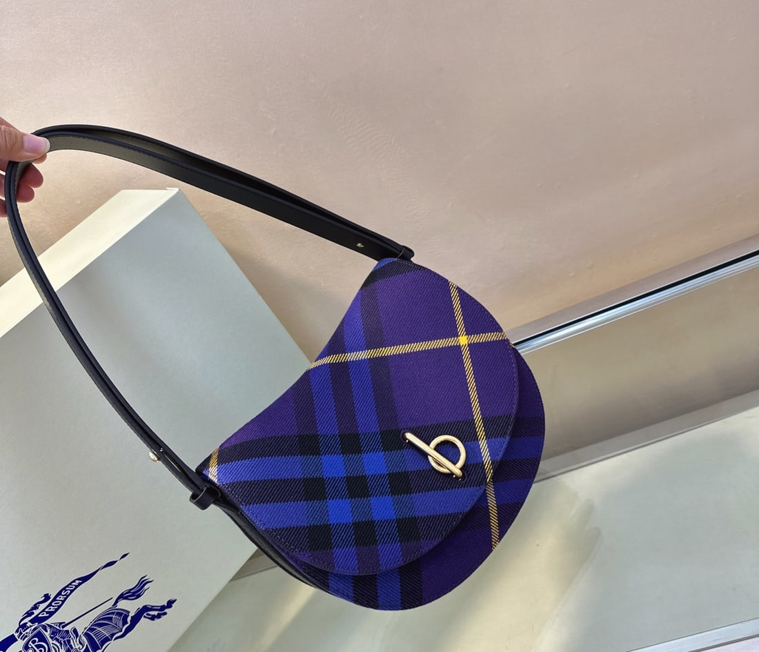 Burberry's structured Banner handbag: The Burberry Banner bag, a structured wool bag crafted in Italy, features a classic Burberry check pattern. Its curved silhouette is inspired by a childhood rocking horse, and the flap closure include