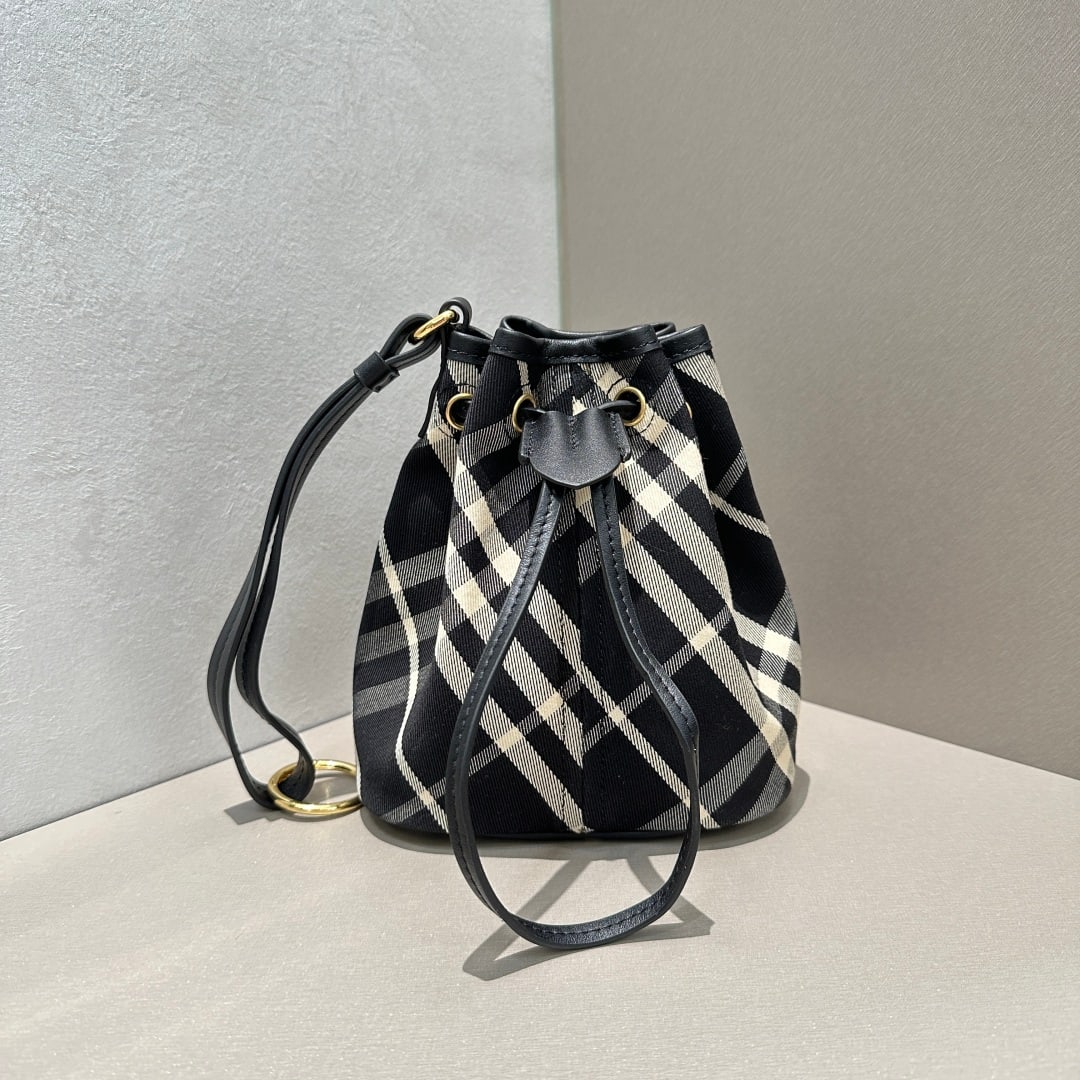 Burberry: This exquisite clutch bag is crafted from soft cotton twill fabric and adorned with Burberry's signature jacquard check pattern. It features a smooth calfskin drawstring and a wrist strap. The leather