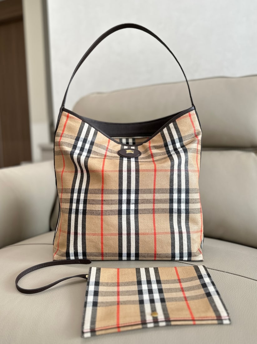 Burberry tote bag: This Burberry tote bag is crafted from a cotton-linen blend and trimmed with smooth calfskin. It features a jacquard Burberry check pattern and a trench coat-inspired coated finish. The interior-free 