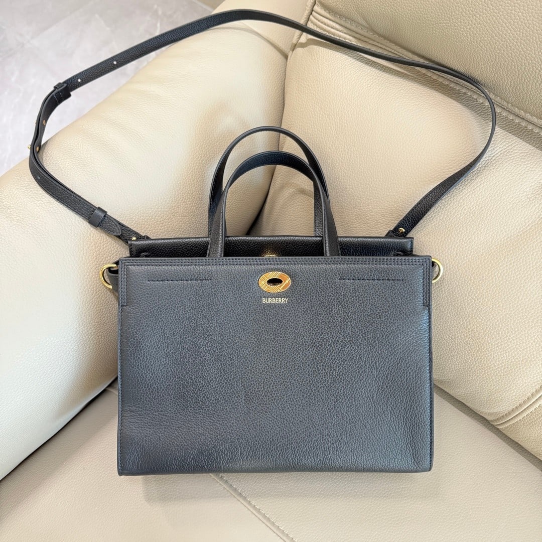Burberry: This Burberry tote bag is crafted from Italian grained calfskin with a cotton-blend lining and finished in the iconic sand-colored Burberry check pattern. Its sophisticated design incorporates a check