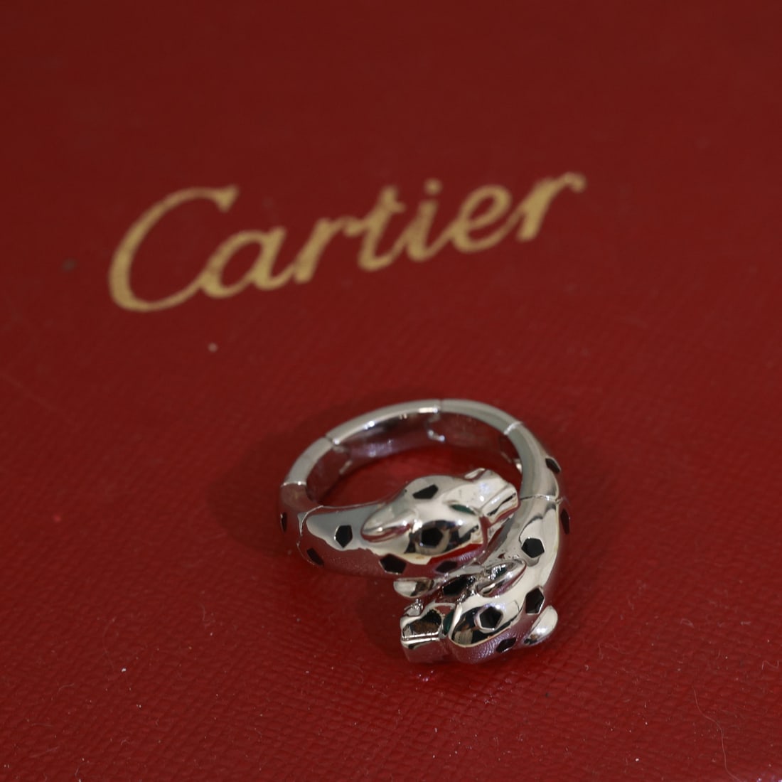 Cartier: Leopard Ring, a bold double leopard head ring, and a Cartier patterned leopard bracelet in 18K white gold! Featuring round brilliant-cut diamonds and emeralds. The leopard Cartier's iconic animal imag