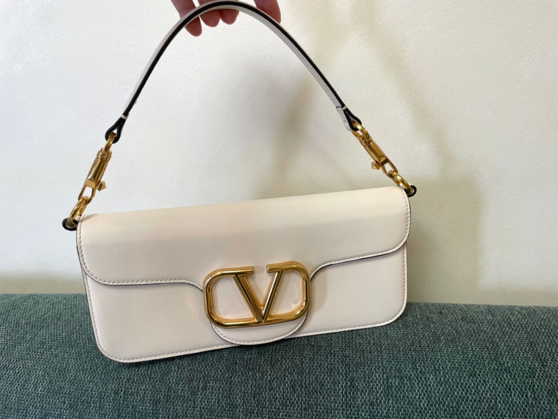Valentino: Valentino calfskin handbag with metal V-logo Signacar trim - features detachable handles and a detachable sliding chain for shoulder, crossbody, or hand carrying. Vintage brass distressed finish hardw