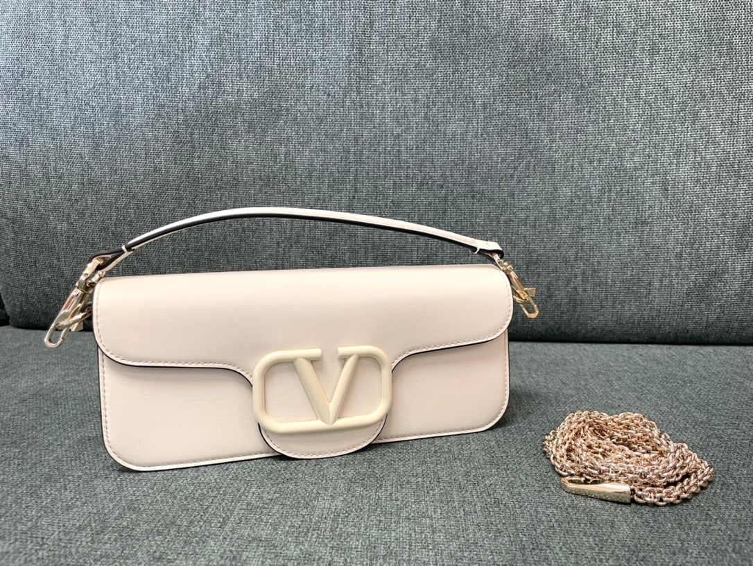 Valentino: White Valentino calfskin handbag with metal V-logo and Signacar design - features detachable handles and a detachable sliding chain for shoulder, crossbody, or hand carrying. Vintage brass distressed 
