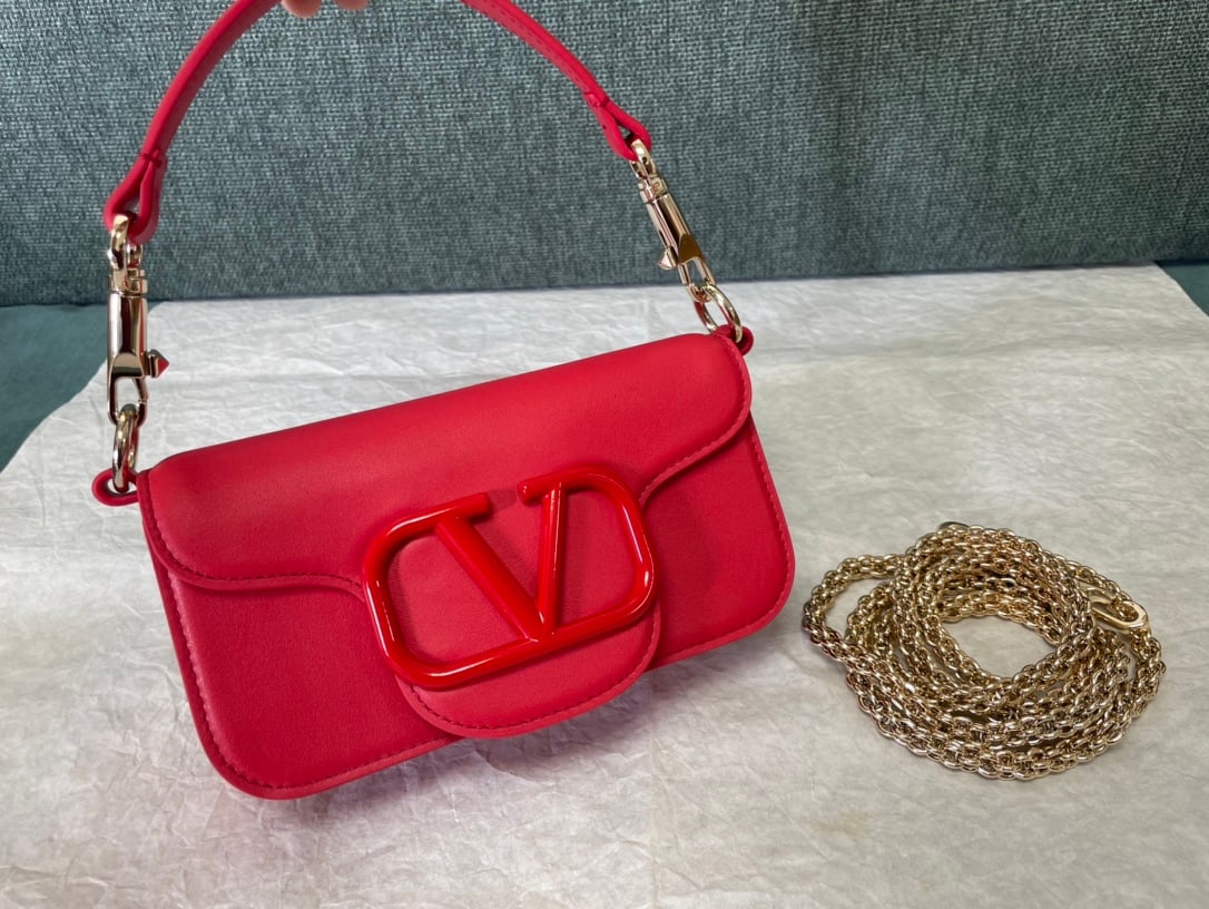 Valentino: Valentino calfskin handbag with bright red buckle and metal V-logo Signacar trim - features detachable handles and a detachable sliding chain for shoulder, crossbody, or hand carrying. Vintage brass d